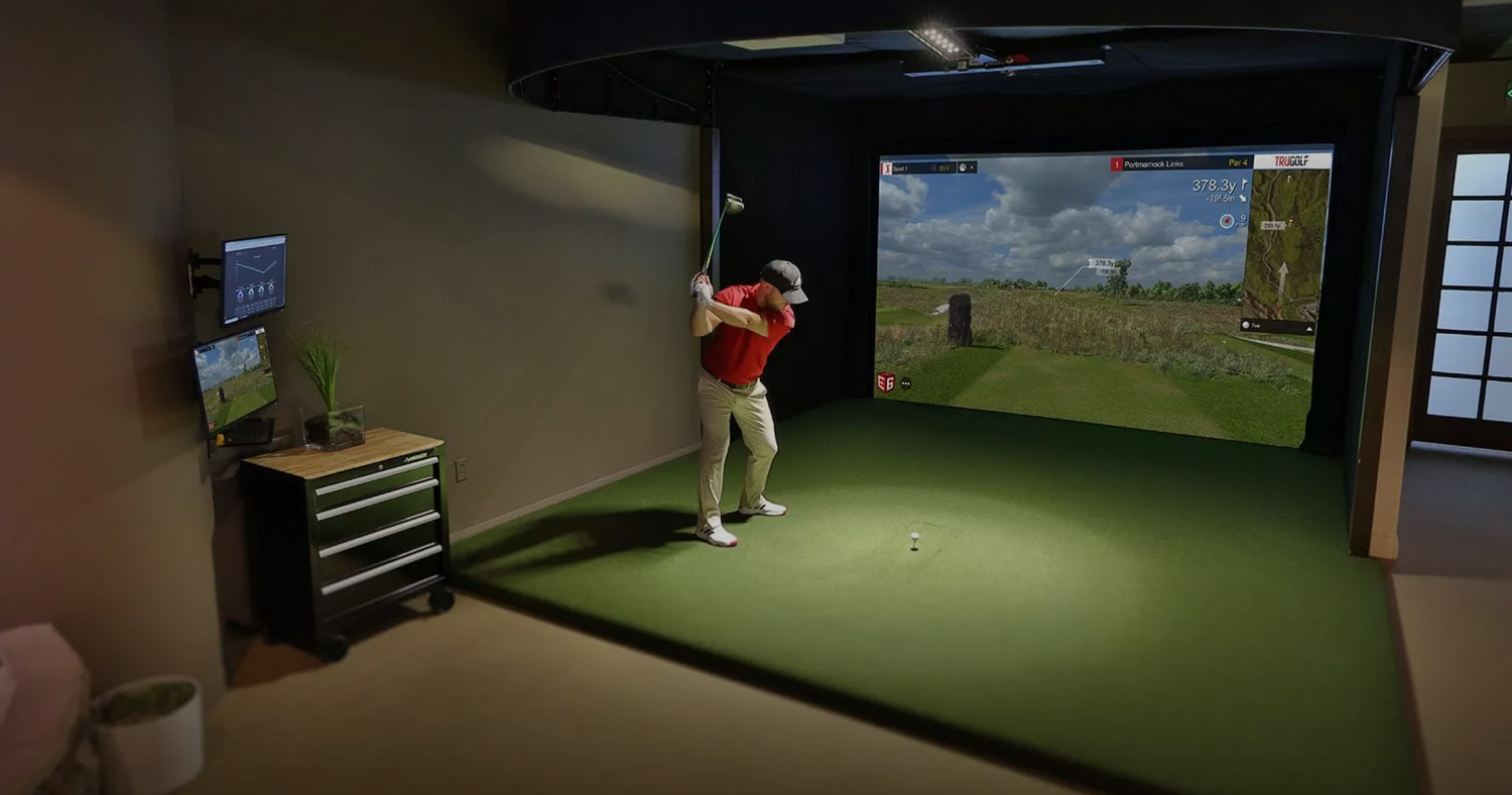 Man standing in front of a TruGolf home golf simulator